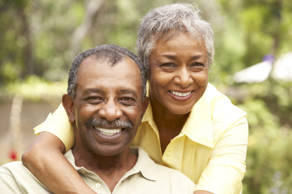 Older couple benefitting from all-on-4 dental implants they received at Cigno Family Dental in Greenfield, WI. 