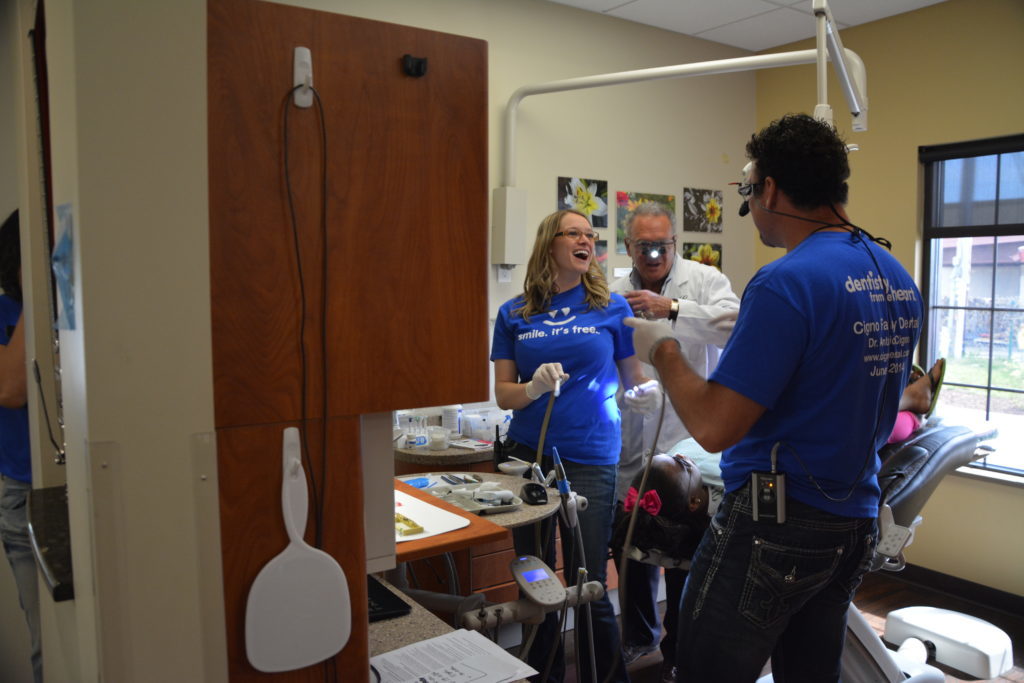 Dr. Cigno consults with staff for treatment during a general dentistry visit by a regular patient. 