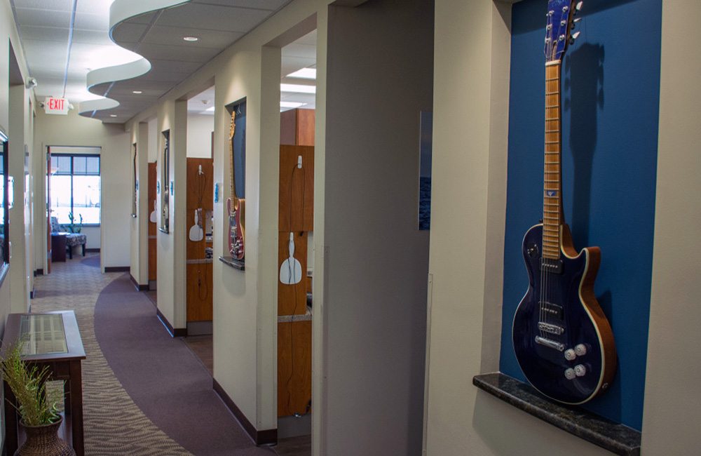 Custom guitars line the walls of the practice hallway. 