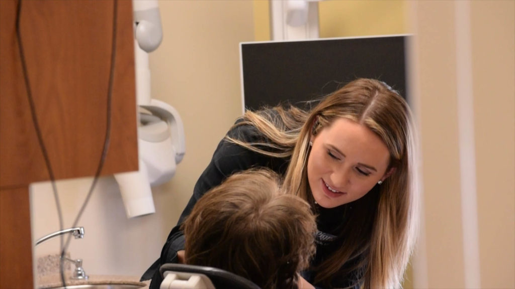 A Cigno Family Dental team member examines a patient coming to the dental clinic for restorative dentistry services in Greenfield, WI.