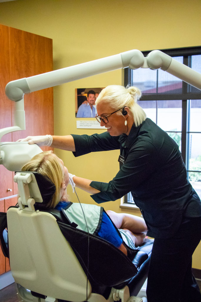 Patient receiving x-rays to help with diagnosis and treatment that involves some cosmetic dentistry options for smile enhancement. 